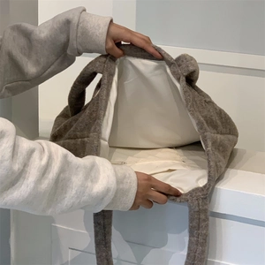 Detail view of large plush tote bag interior with soft fleece texture and spacious lining