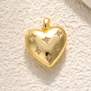Detail view of 18K gold heart pendant with leopard pattern and sparkling crystals
