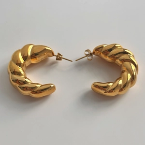 Polished 18k gold plated hollow twisted hoop earrings with a metallic texture