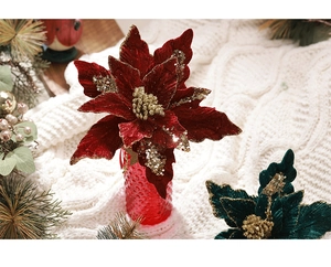 Fleur de noël en velours rouge avec paillettes dorées dans un vase texturé pour décoration