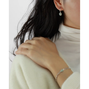 Detail shot of s925 silver bracelet and earrings set with green aventurine stone