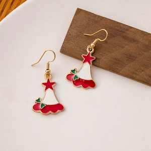 Detail view of festive red and green Christmas hat earrings with gold stars and ear hooks