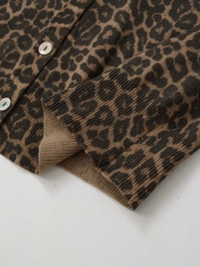 Detailed close-up of leopard print knit cardigan showing ribbed cuffs and glossy buttons