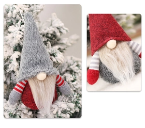 Detail of Christmas forest gnome hanging ornaments with plush texture on a snowy tree