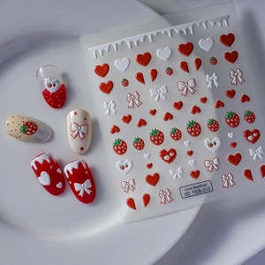 5D embossed nail art stickers with 3D strawberry heart bow designs on white ceramic plate