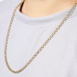 Close-up of golden stainless steel rolo chain necklace worn by a fashion model