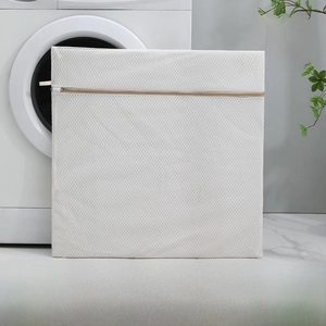 Detail view of beige extra large 60x60cm honeycomb mesh laundry bag with secure zipper