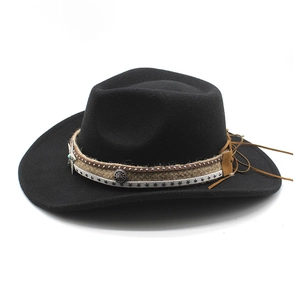 Detail of black wool felt cowboy hat with metallic star badge and leather tassels