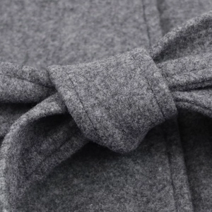 Macro detail of soft grey wool coat fabric texture with stitching and matching waist belt