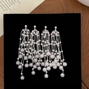 Elegant silver pearl tassel earrings featuring cascading bead chains and luxury design