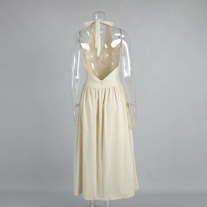 Detail of beige cotton halter neck maxi dress with open back and waist tie design