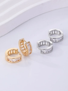 Close-up of gold and silver huggie hoop earrings with sparkling pave-set cubic zirconia