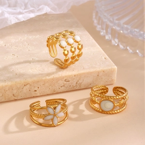 Three-piece set of gold-plated stainless steel rings with white enamel floral accents