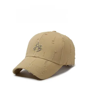 Detailed shot of beige distressed baseball cap featuring 3D embroidered letter B design