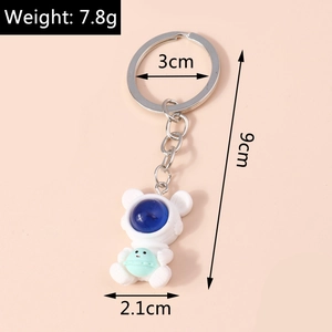 Detail view of astronaut bear keychain with blue visor and dimensions in centimeters