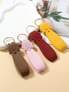 Detailed view of four colorful PU leather pig keychains with round metal rings