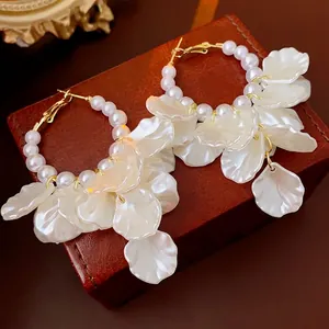 French vintage hoop earrings with white pearls and petals on a premium leather box