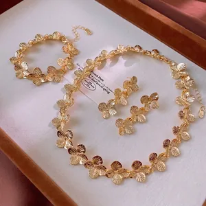 Elegant gold flower jewelry set with necklace bracelet and earrings in matte finish