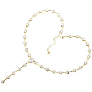 Detail of a golden heart necklace with clear zircons and lobster clasp on white surface