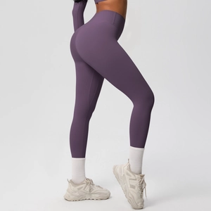 Detail showing the sculpting seam and high-waisted fit of deep purple yoga leggings
