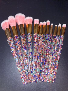 Detail of 13 professional makeup brushes with gradient bristles and rhinestone handles