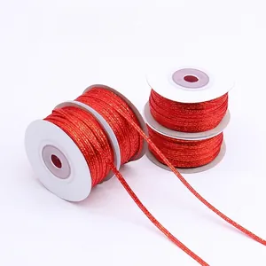 Three rolls of red and gold metallic glitter ribbon for gift wrapping and DIY crafts