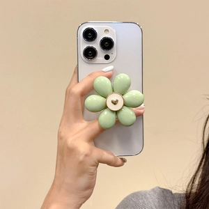 Green flower phone grip with golden heart on white mobile phone background