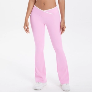 Detail of pink high-waisted flare yoga pants with V-shaped white contrast cross waist