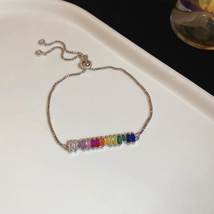 Detailed close-up of rainbow zircon tennis bracelet with silver finish and bolo clasp