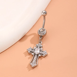 Detail of silver heart cross belly ring with sparkling zircon insets on white board