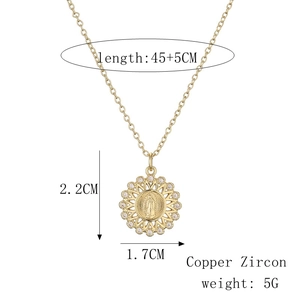 Macro detail of gold plated sunburst pendant with religious relief and zircon inlay
