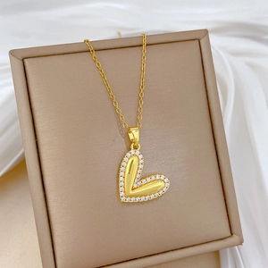 Macro shot of gold-plated heart pendant necklace with zircon inlay in a gift box