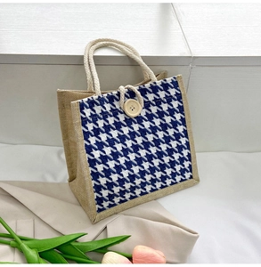 Detail of canvas tote bag featuring houndstooth fabric, jute base and woven rope handles