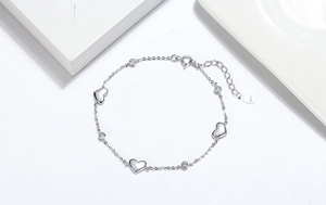 Macro detail of S925 sterling silver heart bracelet with cubic zirconia and extension chain