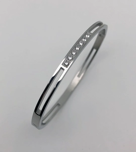 Macro shot of 4mm silver titanium steel hollow bangle with eight inset clear zircons