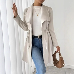 Detail showing the adjustable drawstring waist and lapel collar of this beige trench coat