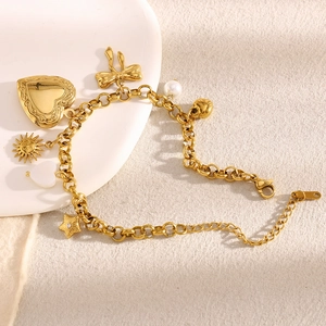 Detail of 18K gold plated charm bracelet with heart, butterfly and pearl pendants