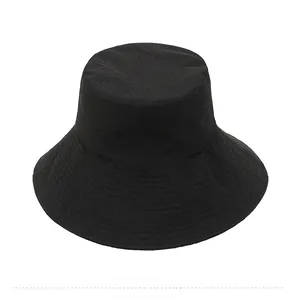Detail of the breathable mesh fabric and vent holes on a black outdoor bucket hat