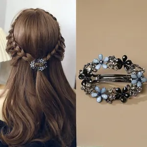 Detail of vintage flower hair clip with blue crystals and spring clamp shown on model