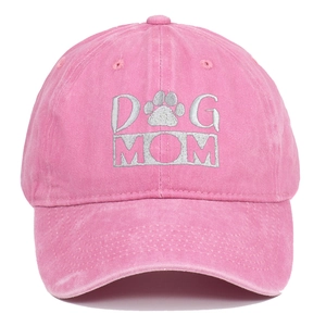 Close-up of pink washed cotton baseball cap featuring white Dog Mom embroidery with paw print