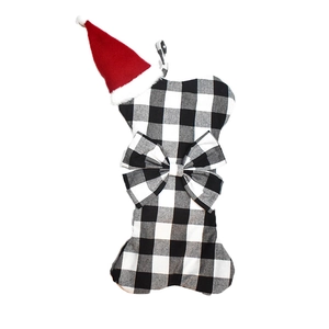 Close-up of bone-shaped Christmas stocking with black white plaid and red hat