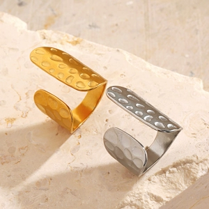 18K gold and silver plated geometric hammered rings on a textured stone display
