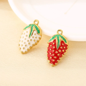 Detailed macro view of red and white 304 stainless steel strawberry charms with gold trim