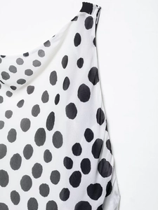 Close-up of black and white polka dot pattern on soft polyester long dress fabric