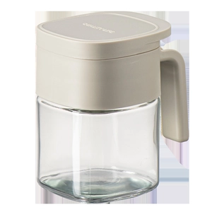 Kitchen glass seasoning jar with handle and airtight lid for spice storage on white background