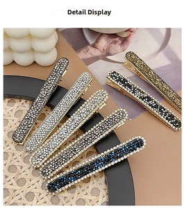 Close-up of sparkling rhinestone duckbill hair clips in various gradient colors