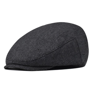 Detail of dark grey herringbone fabric on a vintage ivy cap for men