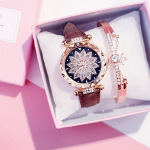Close-up of rose gold watch with floral diamond dial and matching star charm bracelet