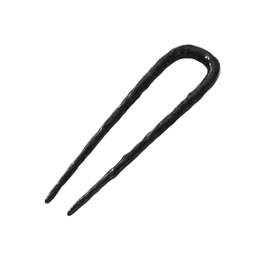 Detail of a wavy textured U-shaped hair pin in black finish for elegant hair styling