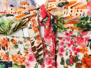 Detail of watercolor floral print dress featuring a tied bow and woven texture